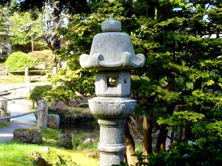 an ornamental stone tower is in the garden