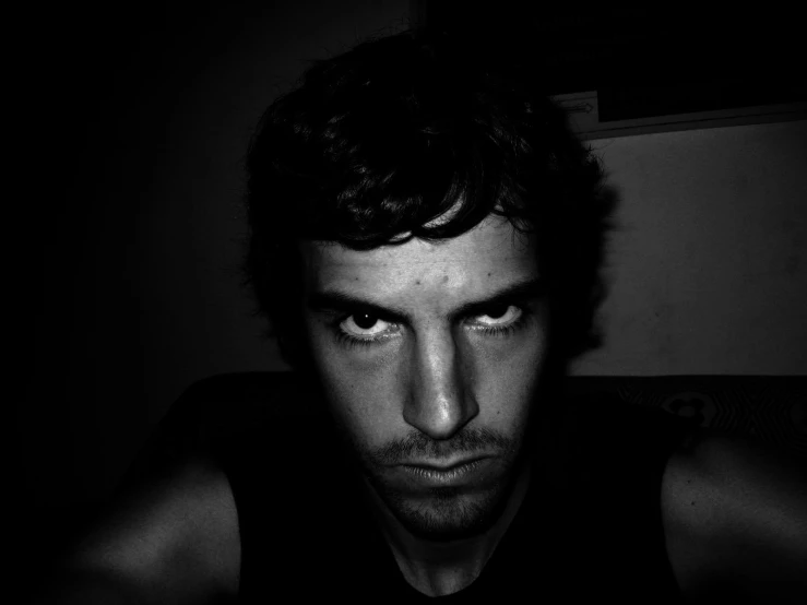 a black and white po of a man in a dark room