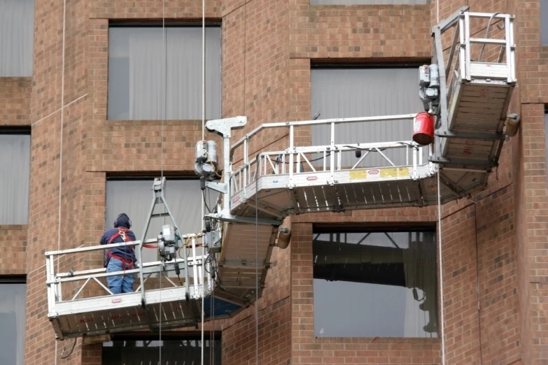 a person on a ladder near a building