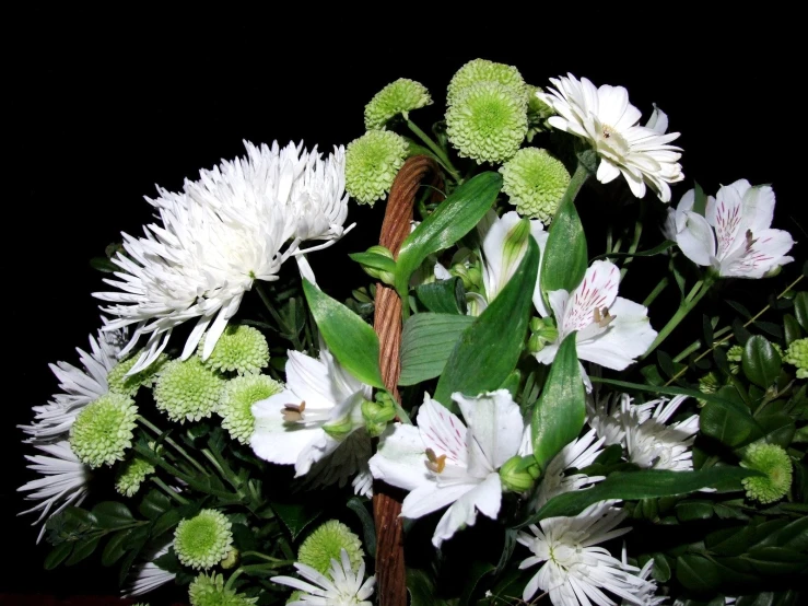 a basket with white flowers on a wooden surface