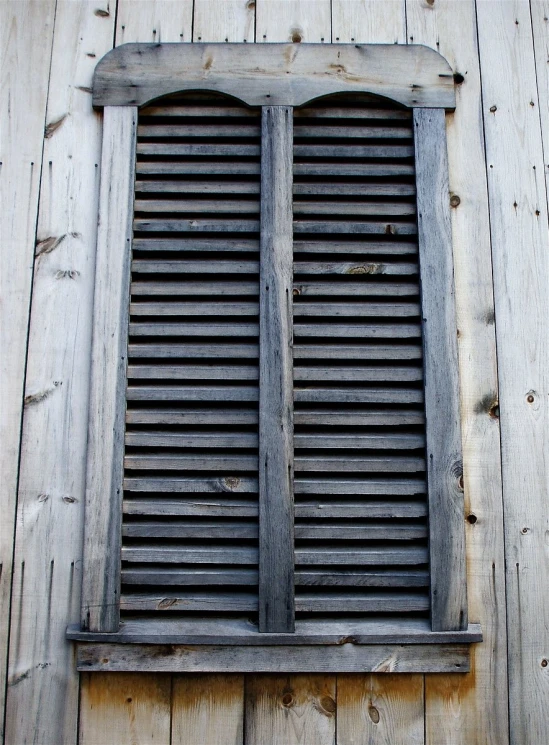 an old wood window on a wooden wall