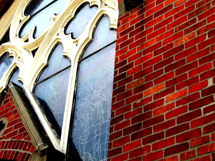 the brick building has a large arched window