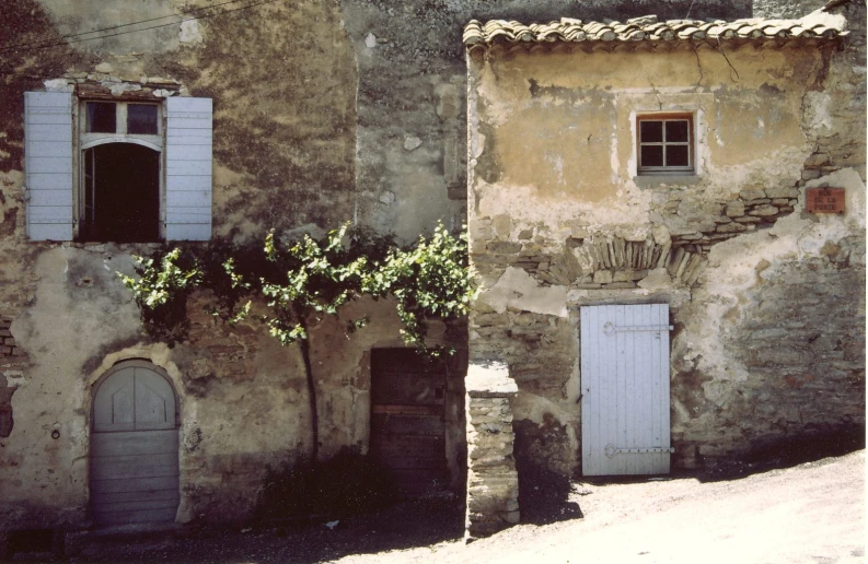 an old building with two separate doorways on the outside