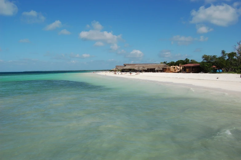 a hut sits on an island above the ocean