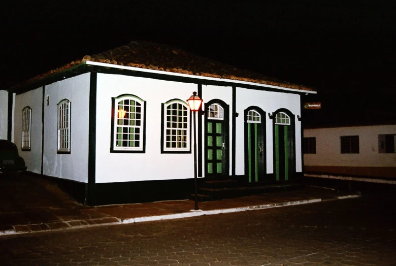 this is an old home with green windows