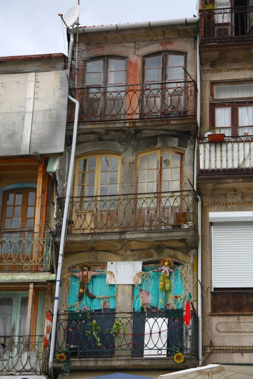 an apartment building has ornate iron railings on each balcony