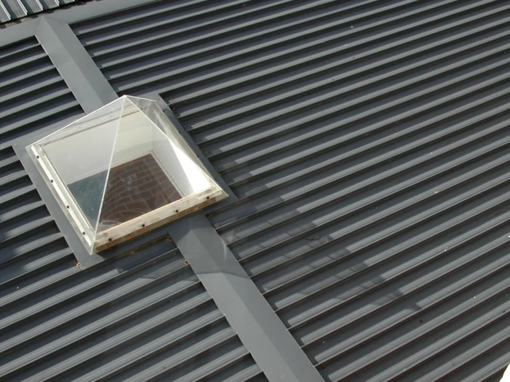 a square window on a metal building near an awning