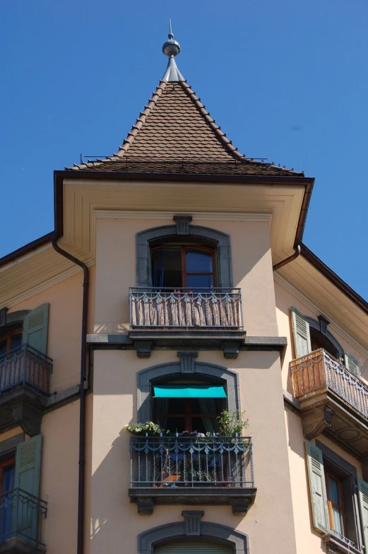 a tall building with lots of windows and balcony railings