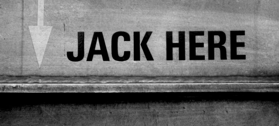 a door with a white arrow and the word jack here in black