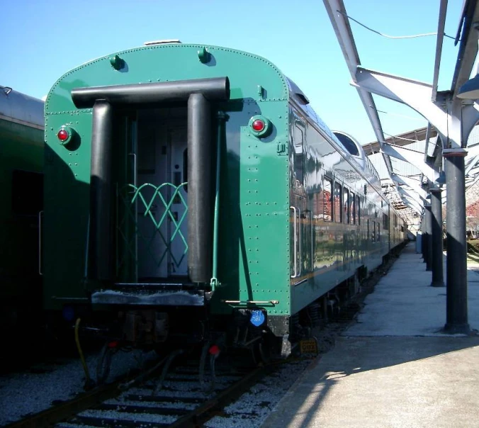 a train that is on some tracks next to a building