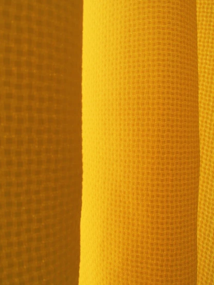 some light yellow sheer fabric with a black background