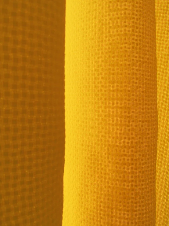 some light yellow sheer fabric with a black background