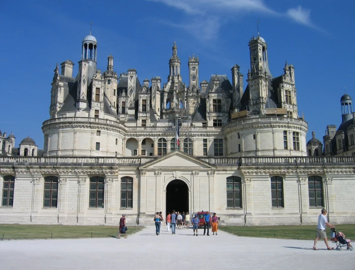 people standing in front of a castle like building