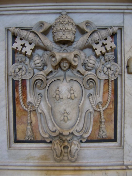 an ornate stone piece mounted on the wall of a building