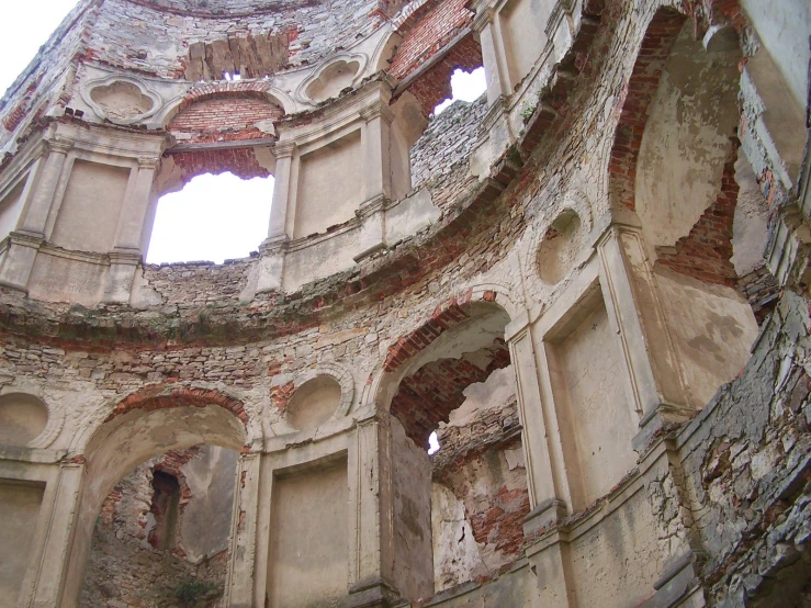 old building with holes and a broken window