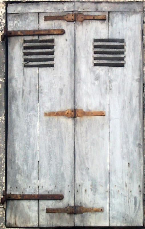 an old wooden door with iron bars and grills