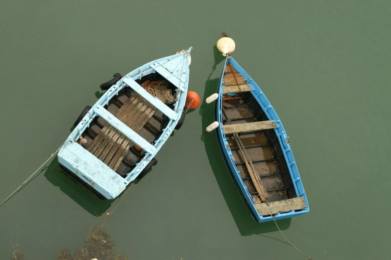 two wooden boats tied up in the water