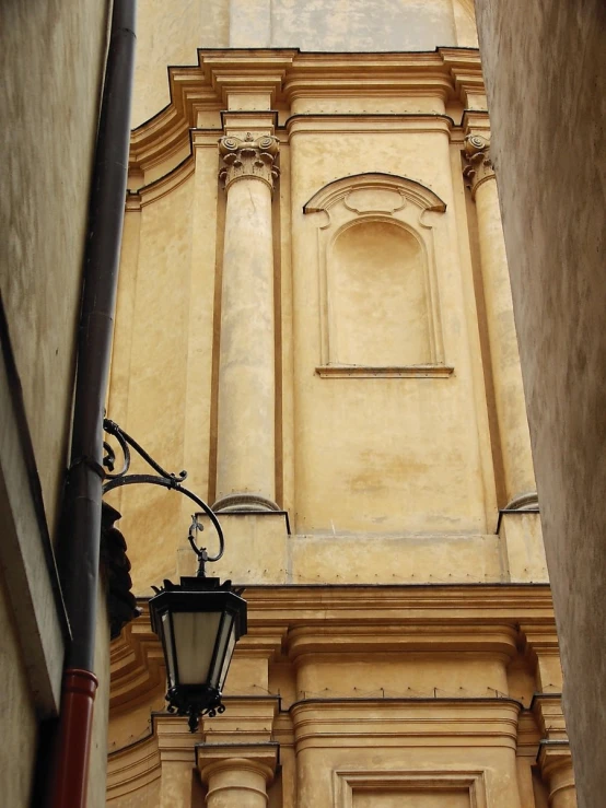 a lamp post and building in a narrow street