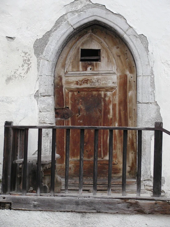 a wooden door that is on the side of a building