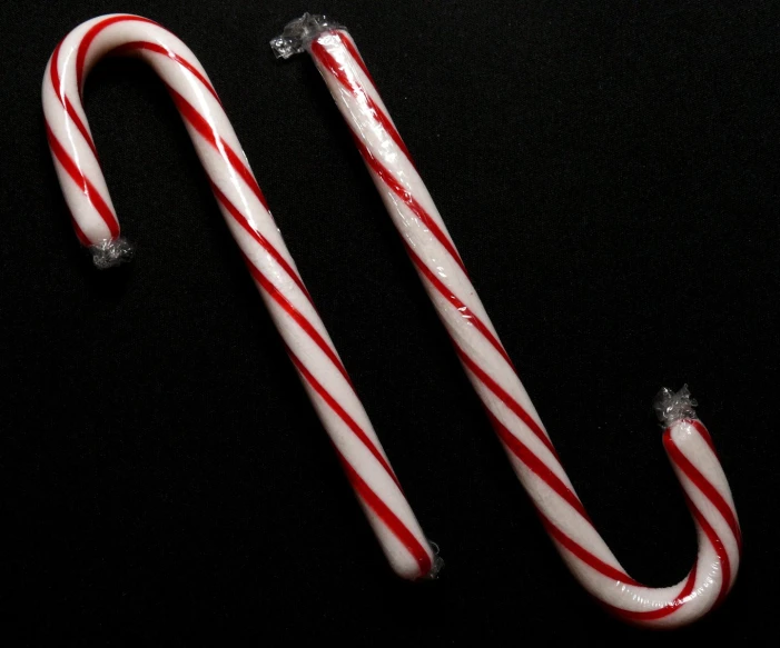 two candy canes are shaped to look like christmas ornaments