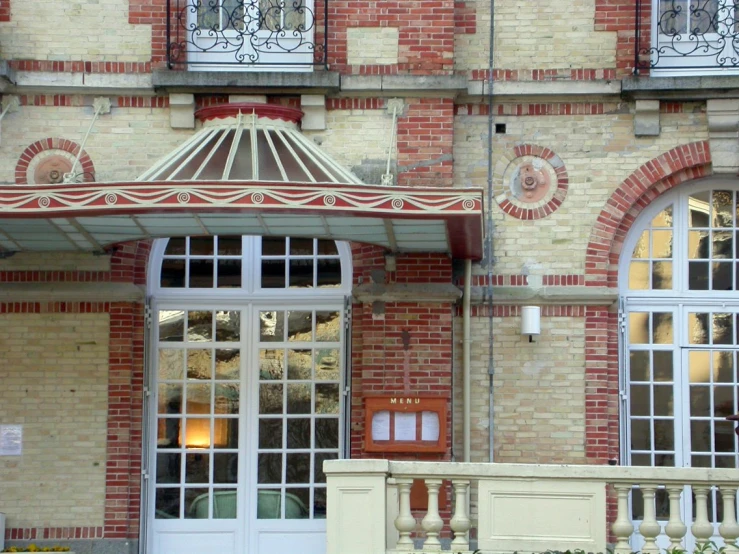 the front entrance to a large brick building with windows