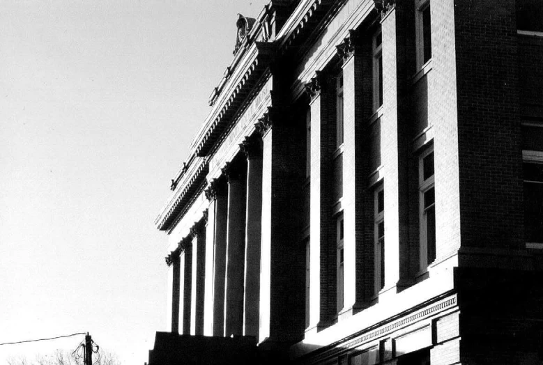 a black and white po of an old building with a clock on top