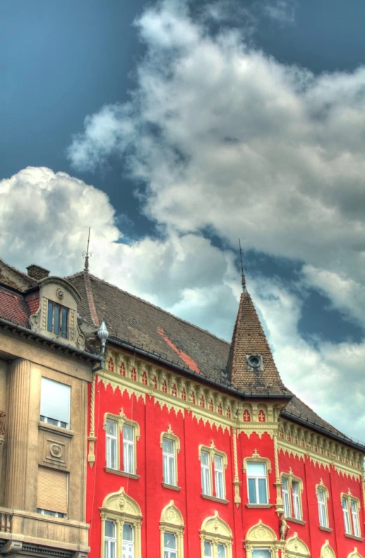 an old red building with a large sky in the background