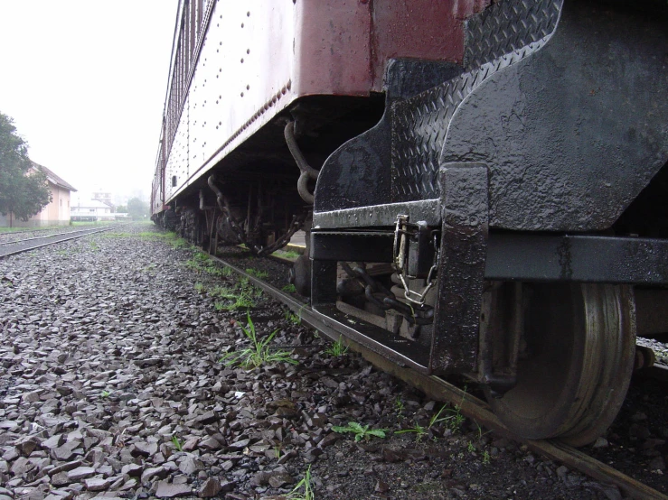 an old train on the tracks by some houses