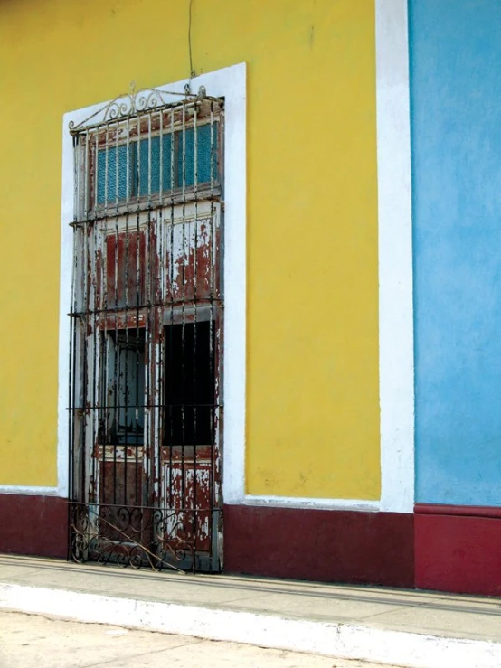 colorful building with open barred iron door in urban area