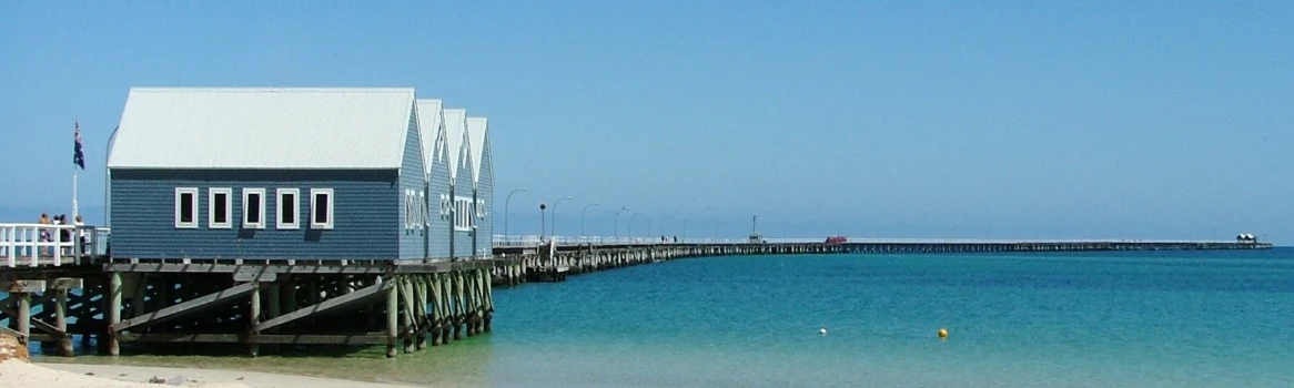 a long dock leading into a small boathouse