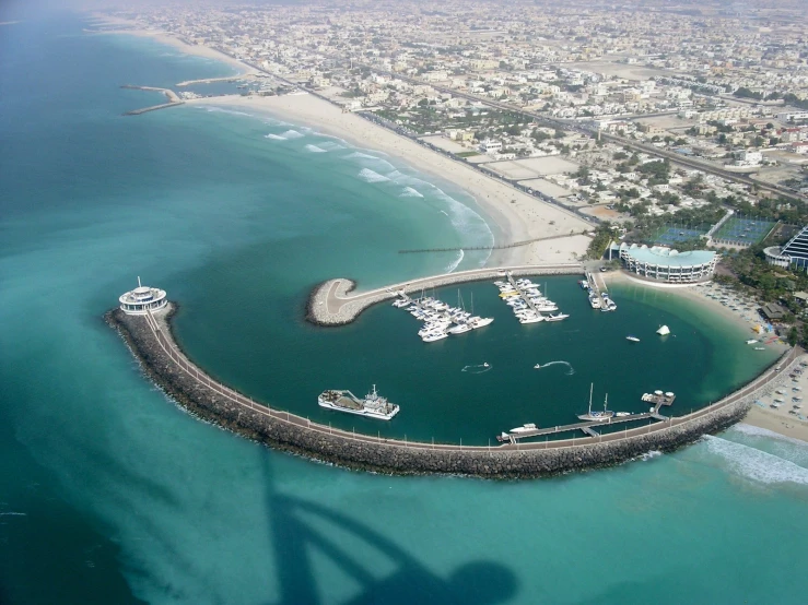 a marina next to the beach in a city