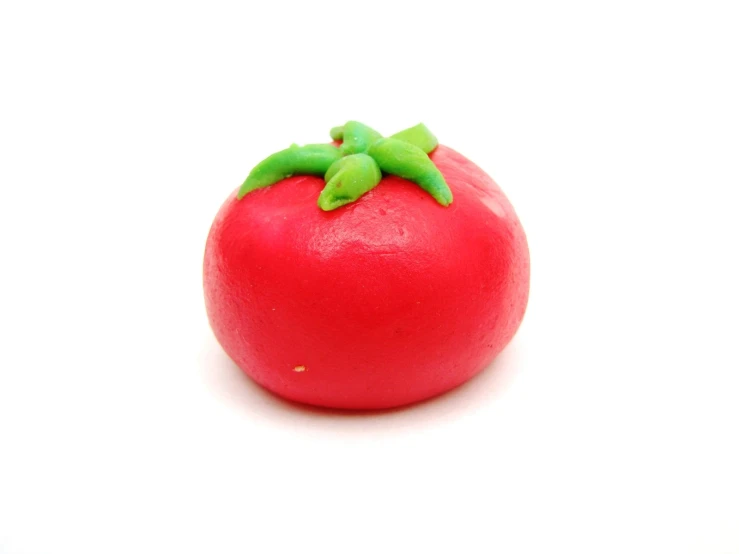 the large ripe tomato has green leaves on it