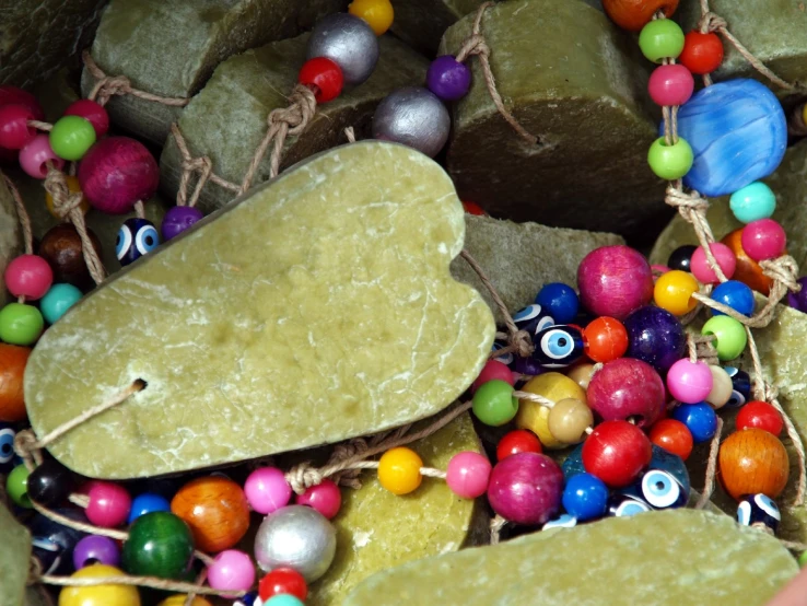 colorful beads are mixed in with a rock