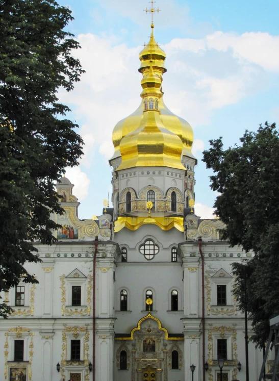 a tall white and yellow building with a clock