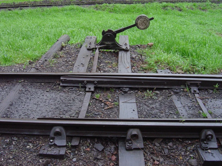 an old and rusty train track that has been bent down