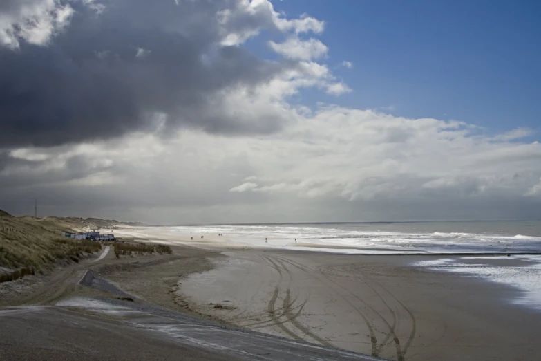 a beach is shown with stormy clouds in the background