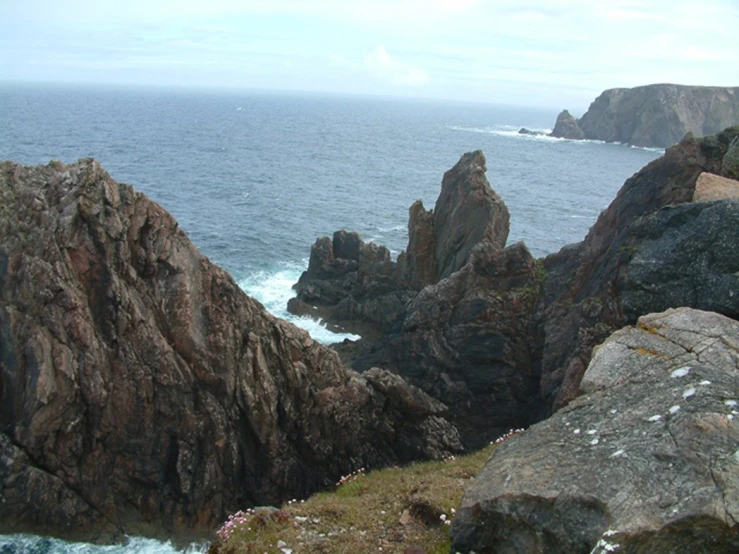 rocky coastline on a cloudy day next to the ocean