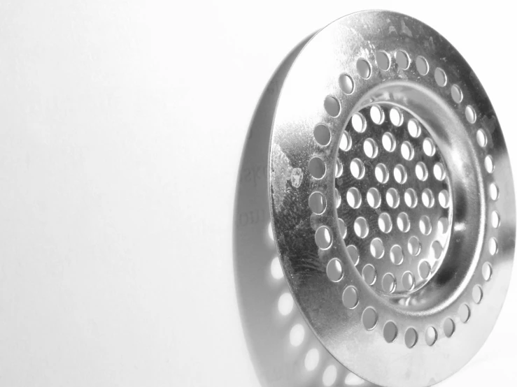 a grater sitting on top of a counter next to a wall