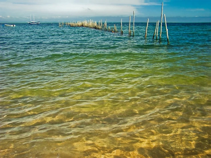 an empty body of water near small wooden piers