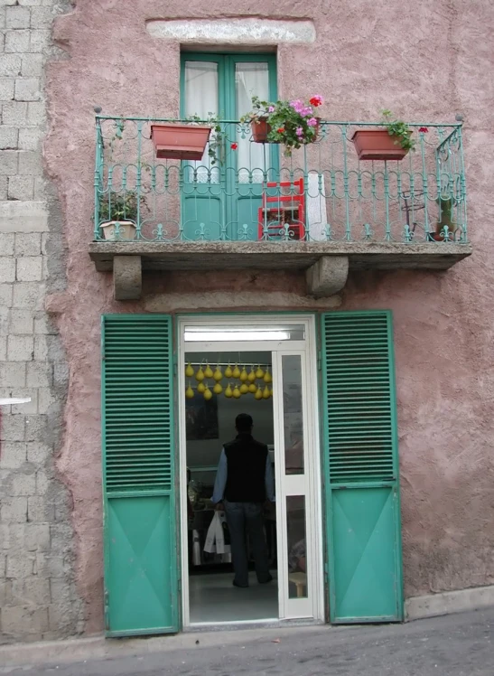 a person is entering a green door through a small window