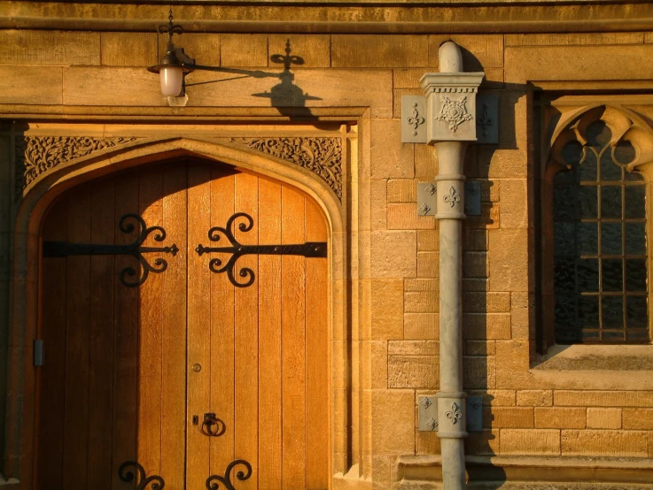 a brown door with iron cross design at the top