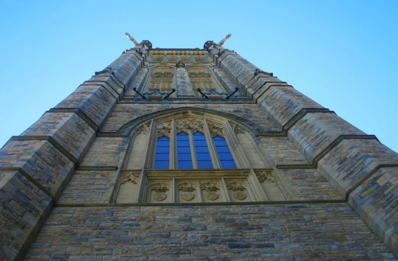 the view from underneath the tower of a large church