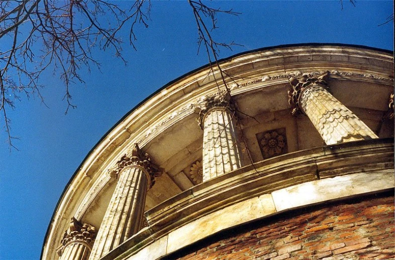 a brick building and several stone columns