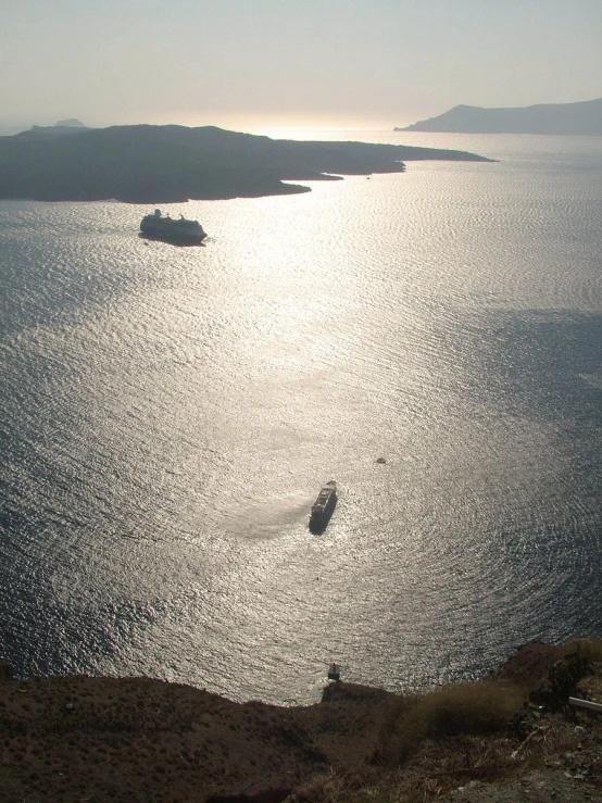 two boats that are in the water and one is a ship