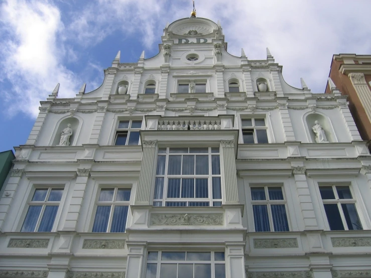 a large building with a tall clock on it's side