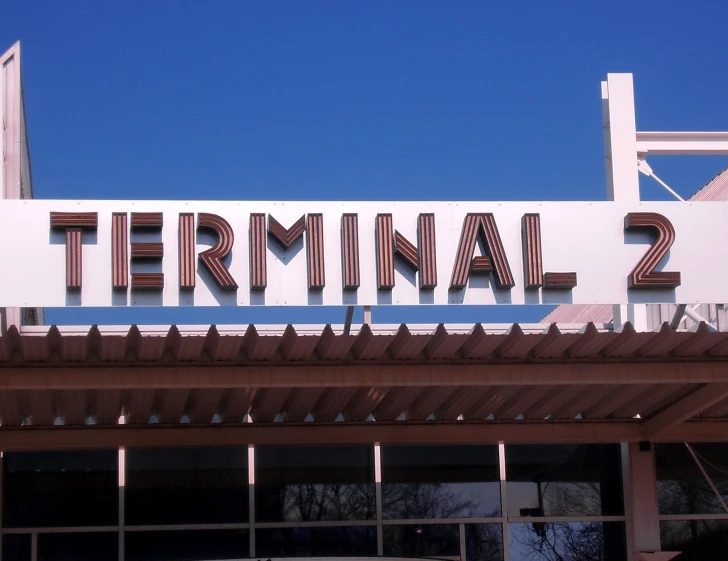 there is a sign on top of the building saying terminal 2