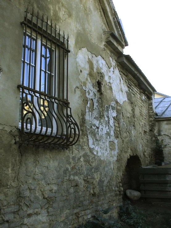 a set of windows and an iron grill on a wall