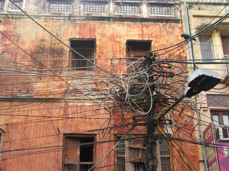 telephone wires hanging from the ceiling of an old building