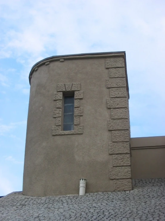 a close up of a brick building with a clock tower in the background