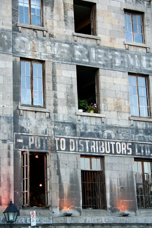 the outside of an old building has windows and is decorated with a sign